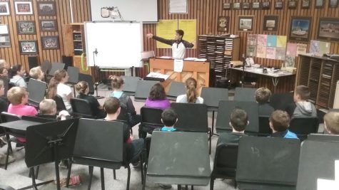 DCHS alum Alex Tello visits 6th grade band
