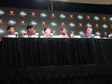 The players and coach of Virginia men's basketball team in a press conference where Delphi Bracketology members looked on.