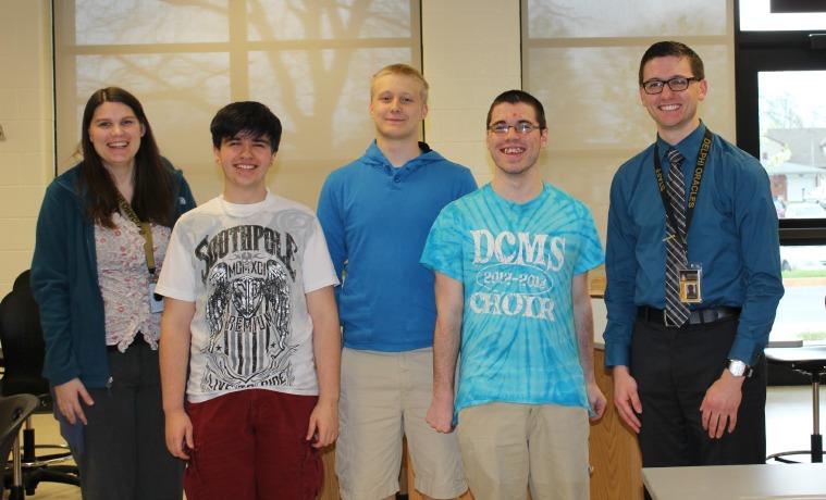 The Varsity Quiz Bowl team poses with their coaches.