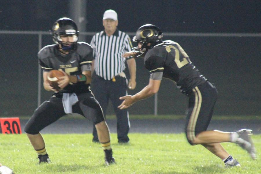 QB Weston Windell hands the ball off to RB Clint Rude