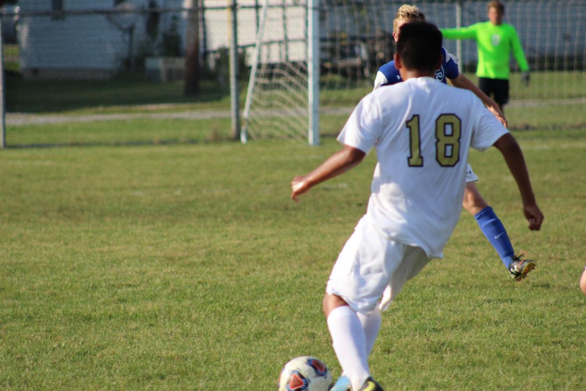 Freshman Ricky Martinez takes on a Carroll defender. Photo taken by Michael ONeil.