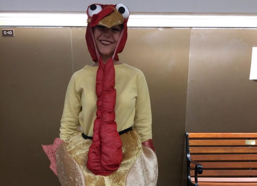 NHS member Kaitlyn Landis demonstrates how cute the turkey is.