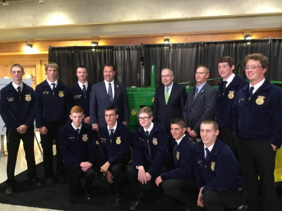 Delphi presents a 1945 John Deere B tractor to John Deere on behalf of National FFA with the CEO of National FFA and the CEO of John Deere present.