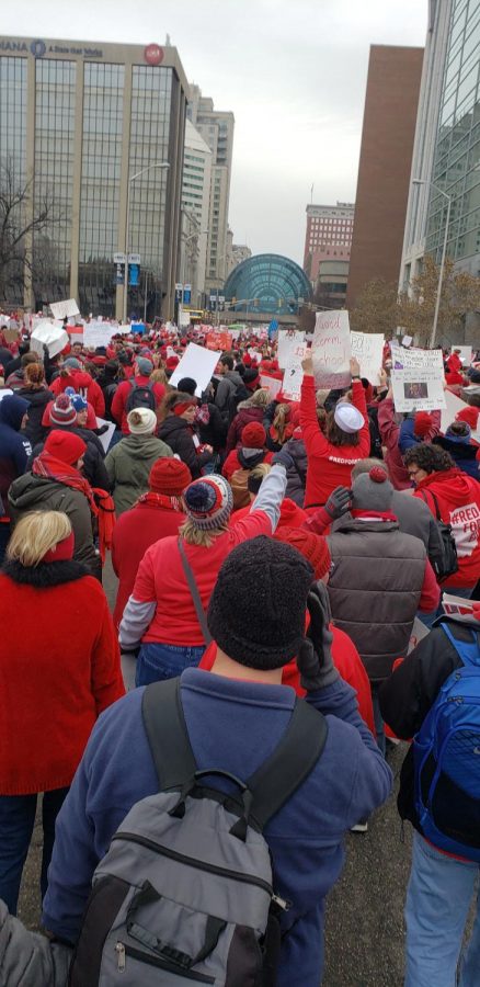 Protester in Indianapolis walk to demand more funding for schools. Indiana is the lowest state in the nation for increase in teachers raises.