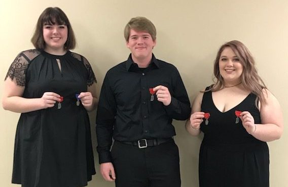 DCHS band members Rylee Houston, Joshua Rush, and Abby Schoen pose with their medals from ISSMA.
