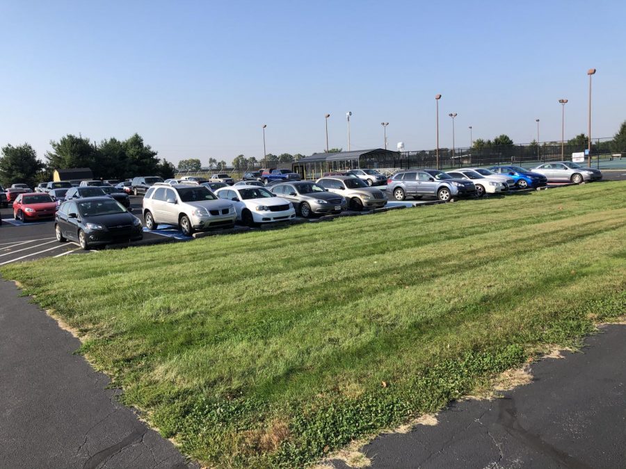 Cars sitting in the student parking lot.