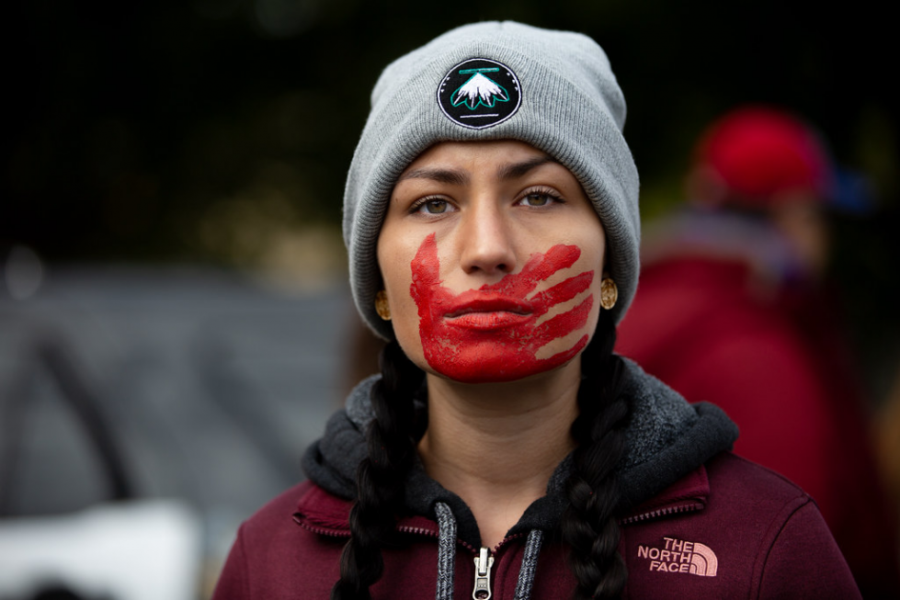 A Native American woman with the symbolic MMIW hand print