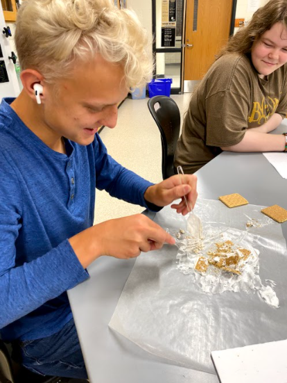 Sophomore Landen Rubright works with graham crackers and whipped cream to model the tectonic plates in first hour ESS. Instead of recreating what an earthquake would look like, Landen decided to destroy the tectonic plates altogether. 