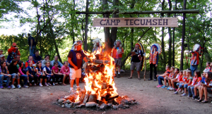 Camp Tecumseh camp fire with counselors and campers.