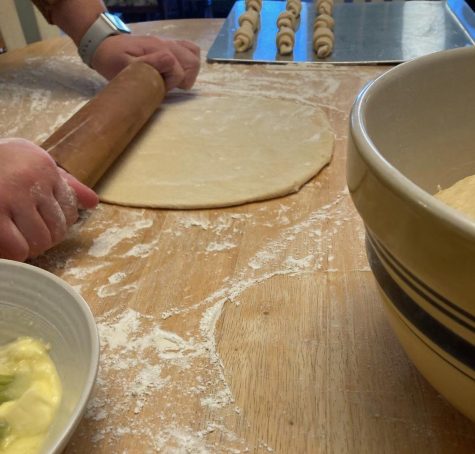 Ella rolling out the dough to roll into the classic crescent shape. 